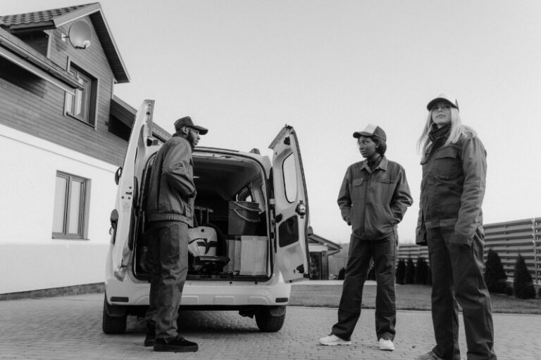 A professional, uniformed junk removal crew standing beside a clean, branded truck in Hemet, California.
